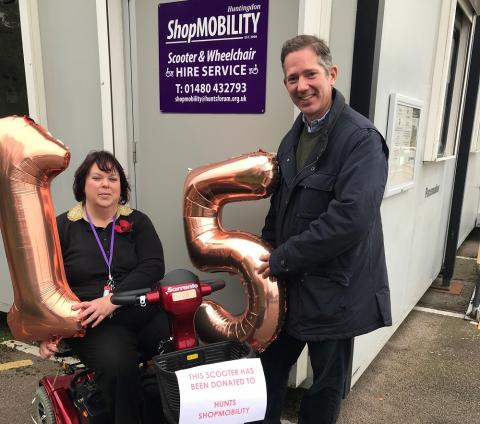Jonathan Djanogly celebrates 15 years of the valuable Huntingdon shopmobility service with manager Celia Barden.